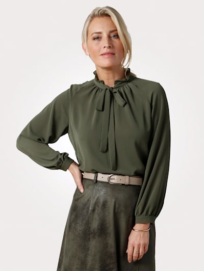 Blouse with a tie neck and frills